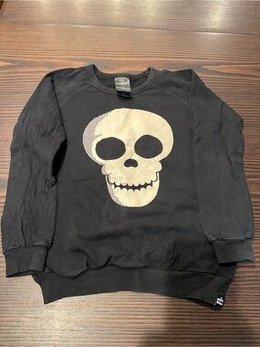 Black Crewneck Sweatshirt with Glow-In-The-Dark Cream Skull Graphic